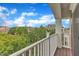 Balcony with a white railing and a neighborhood view of the sky, trees, and houses at 9211 Calabria Dr # 104, Raleigh, NC 27617
