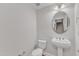 Half bathroom features a stylish pedestal sink and updated fixtures at 9211 Calabria Dr # 104, Raleigh, NC 27617