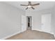 Bright bedroom with neutral carpet, ceiling fan, and convenient access to closet and bathroom at 9211 Calabria Dr # 104, Raleigh, NC 27617