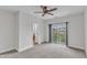 Large bedroom with a ceiling fan and sliding doors to the balcony at 9211 Calabria Dr # 104, Raleigh, NC 27617