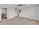 Spacious bedroom with a ceiling fan, view of stairs, and a door to the bathroom at 9211 Calabria Dr # 104, Raleigh, NC 27617