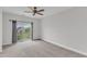 Spacious bedroom with a ceiling fan and sliding doors to the balcony at 9211 Calabria Dr # 104, Raleigh, NC 27617