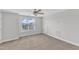 Bedroom with a ceiling fan and large window offering natural light at 9211 Calabria Dr # 104, Raleigh, NC 27617