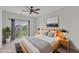 Bright bedroom with a ceiling fan, balcony access, and an art piece on the wall at 9211 Calabria Dr # 104, Raleigh, NC 27617
