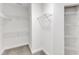 Walk-in closet featuring multiple wire shelving units for ample storage space at 9211 Calabria Dr # 104, Raleigh, NC 27617