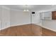 Open-concept dining area with hardwood floors, stylish chandelier, and easy access to the kitchen and living spaces at 9211 Calabria Dr # 104, Raleigh, NC 27617