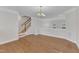 Dining room and staircase showcasing the hardwood floors and an open plan layout, complemented by elegant lighting fixtures at 9211 Calabria Dr # 104, Raleigh, NC 27617