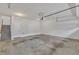 Spacious unfinished garage with white walls, concrete floor, and access to upper-level stairs at 9211 Calabria Dr # 104, Raleigh, NC 27617