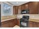 Another angle showing the appliances, granite countertops, and cabinetry at 9211 Calabria Dr # 104, Raleigh, NC 27617