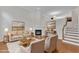Elegantly staged living room with hardwood floors, fireplace, and tasteful decor, creating a warm and inviting ambiance at 9211 Calabria Dr # 104, Raleigh, NC 27617
