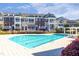 Community pool with lounge seating and nearby townhomes offers a great outdoor retreat at 9211 Calabria Dr # 104, Raleigh, NC 27617