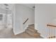 Carpeted stairway with a wooden handrail leading to the upper level of the home at 9211 Calabria Dr # 104, Raleigh, NC 27617