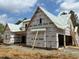 New construction home featuring wood framing, protective wraps, and a modern design at 93 Bur Oak Ct, Pittsboro, NC 27312