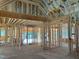 Open-concept home framing shows exposed beams, with interior walls, wiring, and plumbing in progress at 93 Bur Oak Ct, Pittsboro, NC 27312