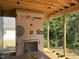 Unfinished porch framing with an installed fireplace offers a glimpse of the wooded backyard at 93 Bur Oak Ct, Pittsboro, NC 27312