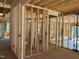 Unfinished new construction room featuring exposed framing, studs, and rough electrical wiring throughout at 93 Bur Oak Ct, Pittsboro, NC 27312
