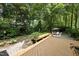 Beautiful backyard with patio, stone pavers, deck and a private wooded view at 1007 Surry Dale Ct, Apex, NC 27502
