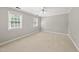 Neutral bedroom features beige carpet, two windows, and a ceiling fan at 1007 Surry Dale Ct, Apex, NC 27502