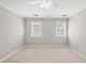 Spacious bedroom features beige carpet, two windows, and a ceiling fan at 1007 Surry Dale Ct, Apex, NC 27502