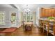 Bright dining area with hardwood floors, chandelier, and natural light from multiple windows at 1007 Surry Dale Ct, Apex, NC 27502