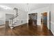 Dining room area featuring hardwood floors, chandelier, and access to kitchen and staircase at 1007 Surry Dale Ct, Apex, NC 27502