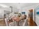 Bright dining room with wood table, upholstered chairs, chandelier, and adjacent staircase at 1007 Surry Dale Ct, Apex, NC 27502