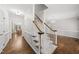 Bright foyer featuring hardwood floors, staircase with carpeted steps, and elegant trim work at 1007 Surry Dale Ct, Apex, NC 27502