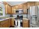 Bright kitchen with wood cabinets, granite countertops, and stainless steel appliances at 1007 Surry Dale Ct, Apex, NC 27502