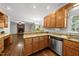 Kitchen features wood cabinets, granite countertops, stainless steel appliances, and seamless living space at 1007 Surry Dale Ct, Apex, NC 27502