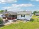 A beautiful backyard with a screened in porch and green grass at 102 Pine St, Dunn, NC 28334