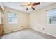 Neutral bedroom features two windows offering lots of natural light at 102 Pine St, Dunn, NC 28334