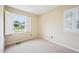 This bedroom has bright natural light and is decorated with white trim and neutral walls at 102 Pine St, Dunn, NC 28334