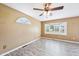 Bright bedroom features hardwood floors, ceiling fan, and bay window with neighborhood views at 102 Pine St, Dunn, NC 28334