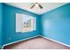 Bright blue bedroom with white trim and single window at 102 Pine St, Dunn, NC 28334