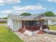 Aerial view of home's exterior featuring a screened porch and established backyard at 102 Pine St, Dunn, NC 28334