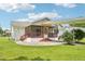 A view of the rear exterior of the home, featuring a screened porch at 102 Pine St, Dunn, NC 28334