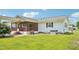 A view of the rear exterior of the home, featuring a screened porch at 102 Pine St, Dunn, NC 28334