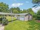 A detached garage and carport sit among well-manicured lawns and mature trees at 102 Pine St, Dunn, NC 28334