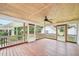 Inviting screened-in porch with wooden floors, ceiling fan, and views of the backyard at 102 Pine St, Dunn, NC 28334