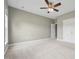 Large carpeted bedroom with neutral paint, a ceiling fan and double closets at 105 Bagley Ln, Dunn, NC 28334