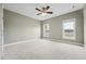Comfortable bedroom with neutral tones, carpet, ceiling fan, and two windows at 105 Bagley Ln, Dunn, NC 28334