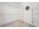 Walk-in closet features built-in shelving, carpet and an octagon window at 105 Bagley Ln, Dunn, NC 28334