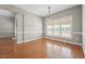 Bright and airy dining room featuring hardwood floors, wainscoting, and a stylish light fixture at 105 Bagley Ln, Dunn, NC 28334