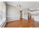 Open dining room with hardwood floors and modern lighting, seamlessly connecting to the kitchen at 105 Bagley Ln, Dunn, NC 28334