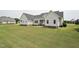 Exterior of home showing tidy lawn, light colored siding, and glimpses of surrounding neighborhood at 105 Bagley Ln, Dunn, NC 28334