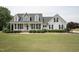 Charming two-story home with a welcoming front porch, manicured lawn, and classic black shutters at 105 Bagley Ln, Dunn, NC 28334