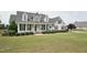 Charming two-story home with a welcoming front porch, manicured lawn, and classic black shutters at 105 Bagley Ln, Dunn, NC 28334