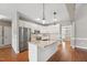 Stylish kitchen with island, white cabinets, stainless steel appliances, and pendant lighting at 105 Bagley Ln, Dunn, NC 28334