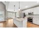Well-lit kitchen with an island, stainless steel appliances, and a view of the dining area at 105 Bagley Ln, Dunn, NC 28334