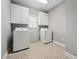 Laundry room with washer, dryer, cabinets and tile flooring at 105 Bagley Ln, Dunn, NC 28334